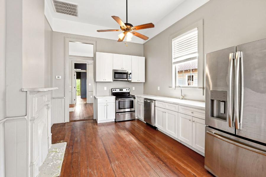 Kitchen with white cabinets, stone countertops and stainless steel appliances