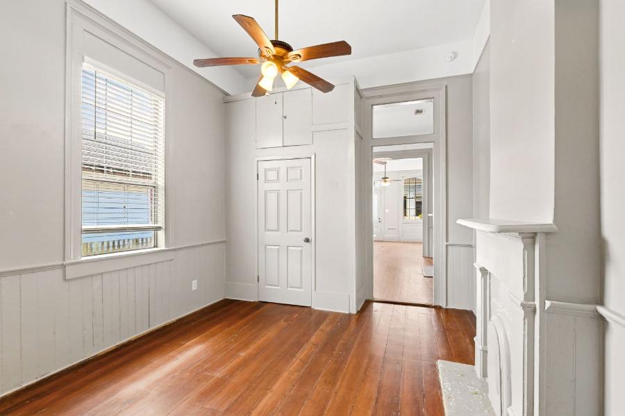 Living area with wainscoting, mantel and hardwood floors