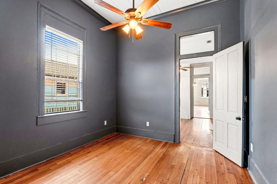 Second bedroom with ceiling fan and hardwood floors