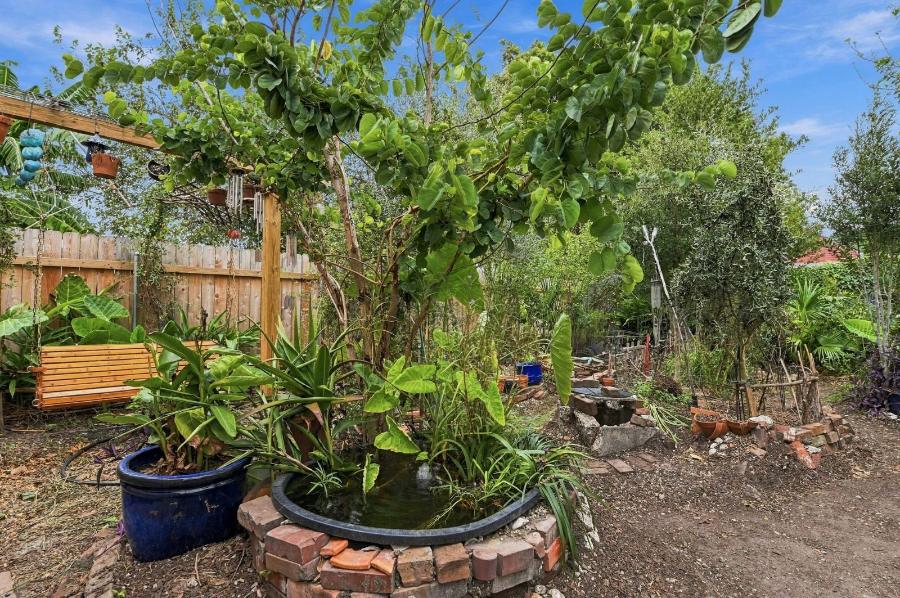 Fenced garden with raised brick planter