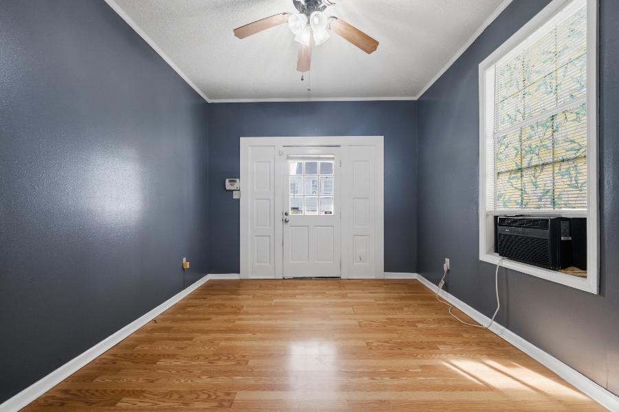 Front room with ceiling fan, laminate wood floors and a stained glass window