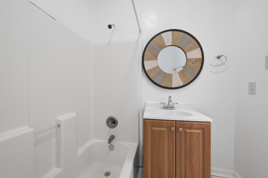 Bathroom with tub and shower and a wood vanity