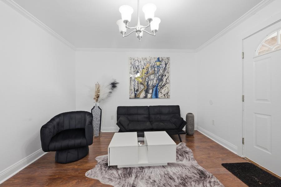 Living room with chandelier, sofa and coffee table