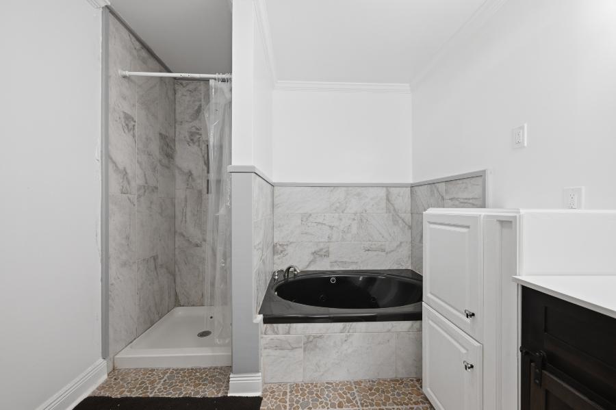 Bathroom with walk-in shower and jetted tub