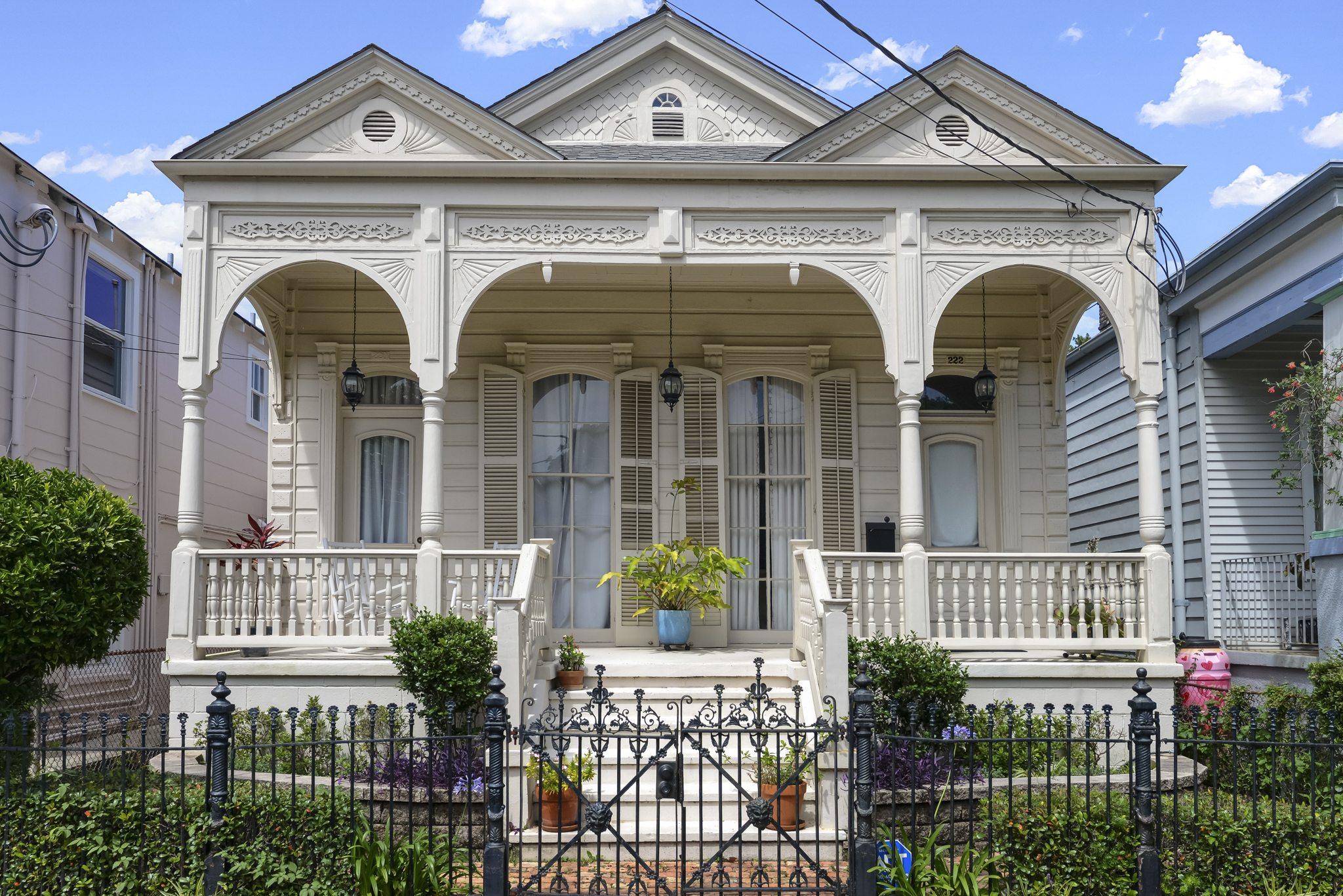 Restored double-gallery Victorian home with ornate millwork in a historic New Orleans neighborhood