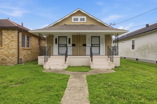 Renovated double shotgun rental home with twin front porch entries in New Orleans