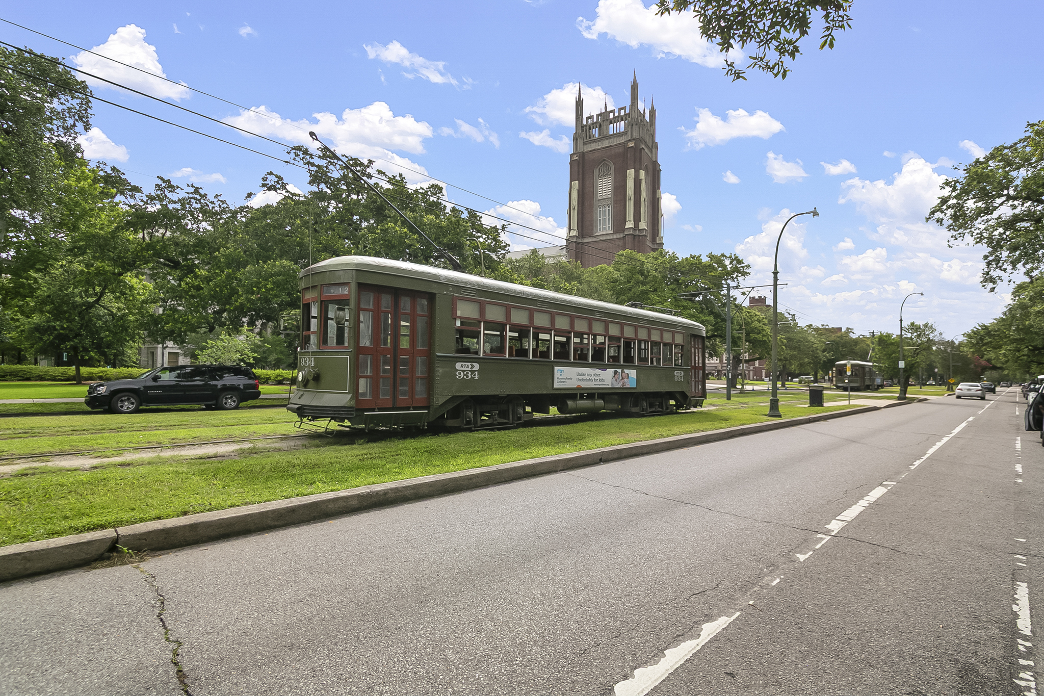 St. Charles Avenue streetcar passing historic New Orleans homes